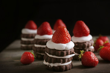 Delicious strawberry cakes on dark background
