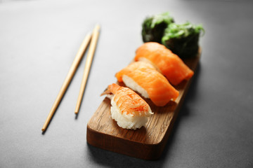Delicious sushi set on wooden board