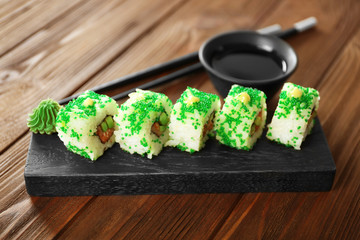 Delicious sushi set on wooden board