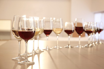 Glasses with red and white wine on table in restaurant