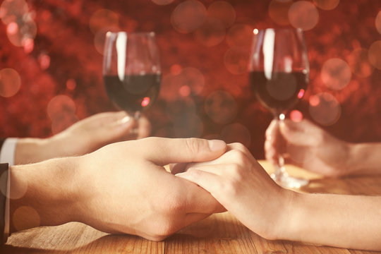 Young couple holding hands together at restaurant