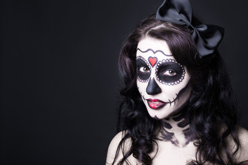 close up portrait of woman with creative Halloween skull make ov