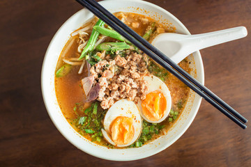 Noodle Tom Yam, hot spicy soup served with boiled egg.