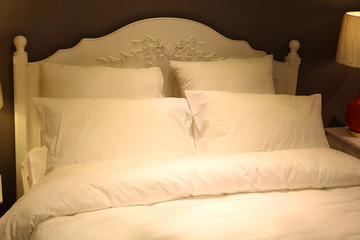 Bed in the interior with lamps