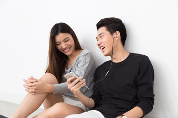 Asian couple listen to music