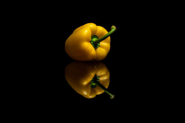 Yellow pepper isolated on black background