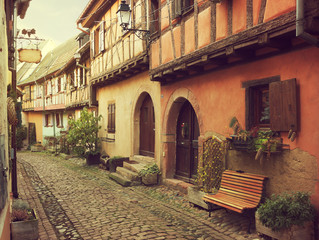 Fototapeta na wymiar Winding street in Eguisheim, north-eastern France. Toned image