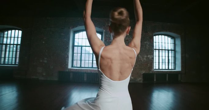 beautiful girl dancer performs elements of classical ballet in the loft design Studio,slow motion