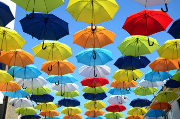 Colorful umbrellas background. Colorful umbrellas in the sunny sky. Street decoration.