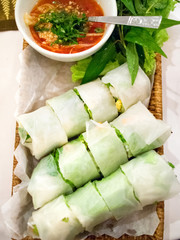 Asian rice spring rolls with red sauce. Shot from above