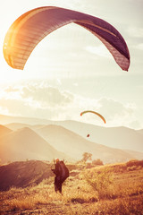 Paragliding extreme Sport with mountains on background Healthy Lifestyle and Freedom concept Summer...