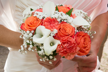 Bride Holding Wedding Bouquet with Orange and white Flowers