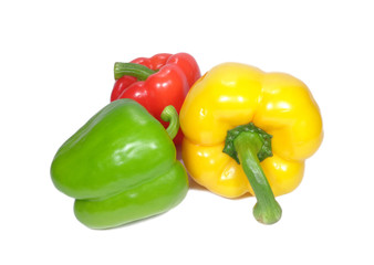 Three bright color ripe bell peppers with green stem, one green, one yellow and one red isolated on white background 