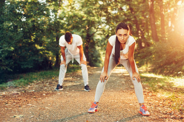 Young couple resting after running in the park