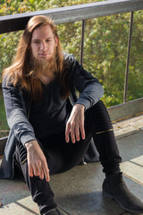 Portrait of man with a long beard and a long hair gone with the