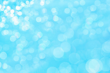 Bokeh soft pastel  blue and white background with blurred  lights. Festive background.