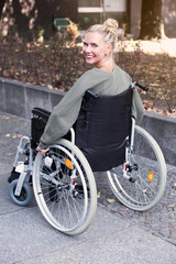 Obraz premium woman in wheelchair smiling at camera