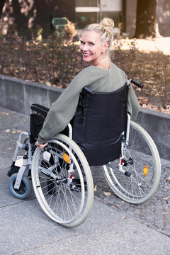 woman in wheelchair smiling at camera