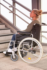 Fototapeta na wymiar woman in a wheelchair in front of stairs