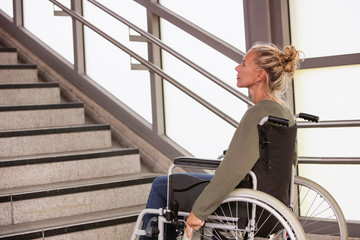 woman in a wheelchair in front of stairs
