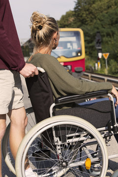 woman in wheelchair at a train station
