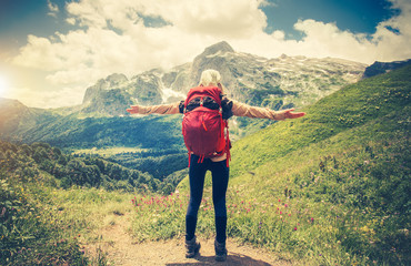 Traveler Woman with backpack hands raised mountaineering Travel Lifestyle concept Summer journey vacations outdoor mountains on background