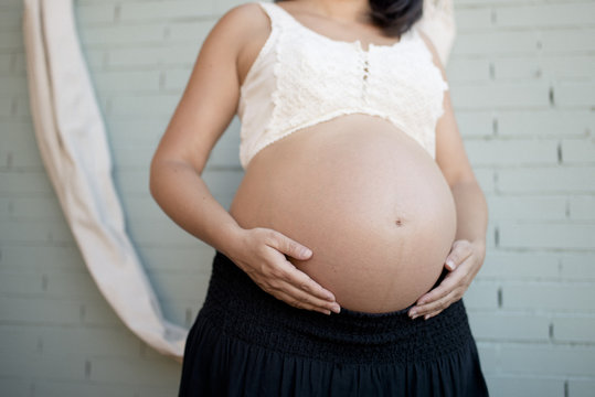 Pregnant holds her belly