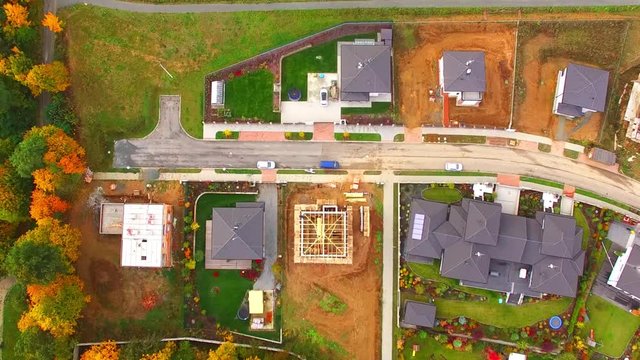 Construction site of new family house. Camera flight over area for pleasant living in suburban district. Construction industry from above.