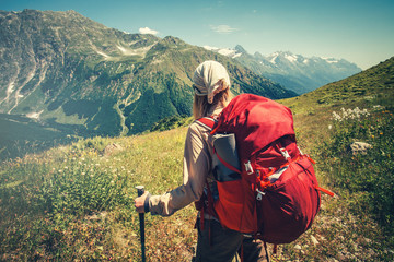 Traveler with red backpack hiking Travel Lifestyle concept active adventure vacations outdoor mountains on background