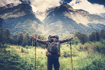 Happy Man with backpack hands raised mountaineering Travel Lifestyle concept beautiful mountains with clouds sky landscape on background adventure vacations outdoor - obrazy, fototapety, plakaty
