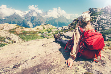 Woman Traveler with backpack admiring of mountains and clouds landscape Travel Lifestyle concept...