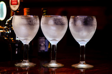 three glasses standing on the bar