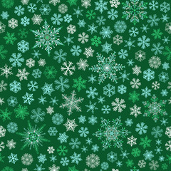 Fototapeta na wymiar Seamless pattern of snowflakes, white and light blue on green