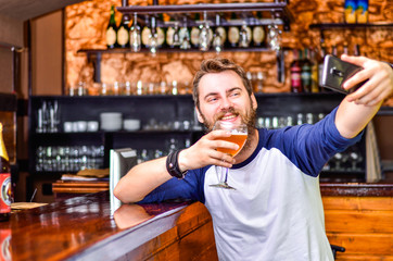 The guy makes selfie with beer in hand