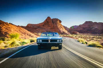 Wall murals Fast cars driving fast through desert in vintage hot rod car