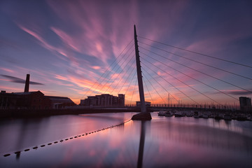 Fototapeta premium Sunrise at the River Tawe and the Millennium bridge in Swansea