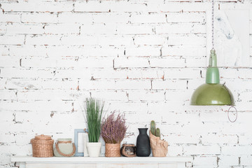 Nicely decorated shelf against brick wall