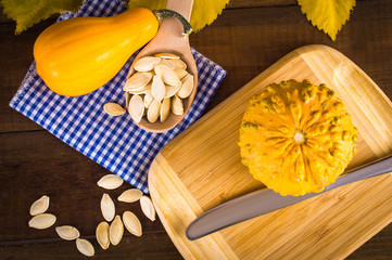 Autumn set. Pumpkins and seeds. On a wooden background. Top view. Flat lay