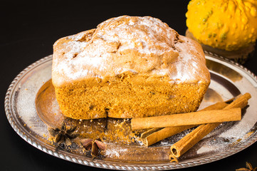 Cupcake with raisins on a tray. Pumpkin and cinnamon. On a wooden background.
