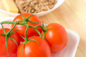 Close-up of fresh, ripe tomatoes on wood background.