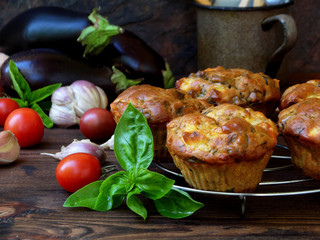 snack savory muffins cakes with eggplant, tomatoes, basil and cheese on wooden background. selective focus