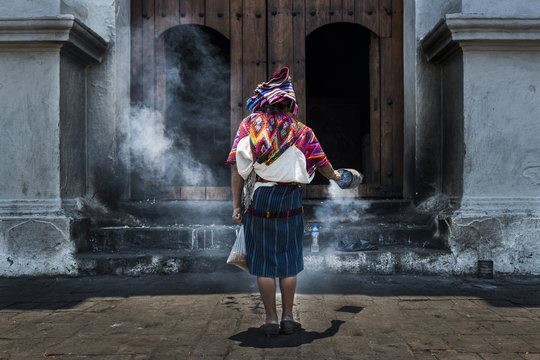 Mayan woman performing a ritual in front of the Santo Tomás church in the town of Chichicastenango, in Guatemala