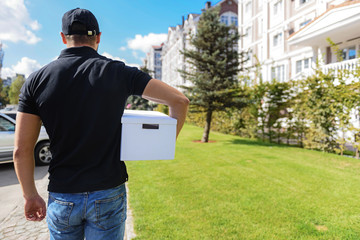 man standing with a cardboard box