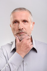 senior man looking into a camera