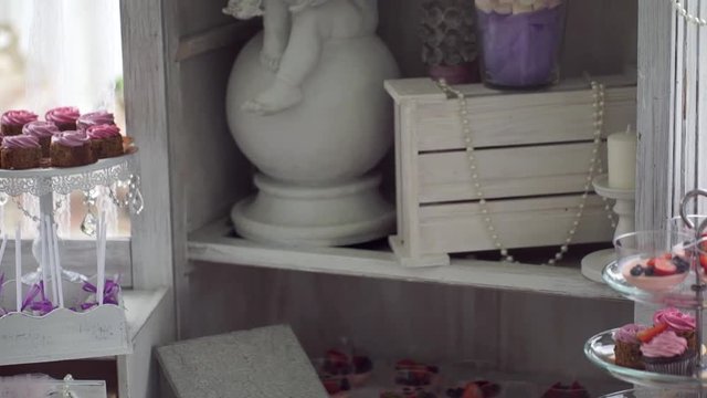 Wedding decorations, angel statue and dessert closeup.