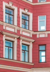 Several windows in row on corner of facade of urban apartment building front view, St. Petersburg, Russia.