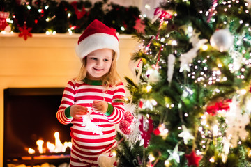 Kids in pajamas under Christmas tree