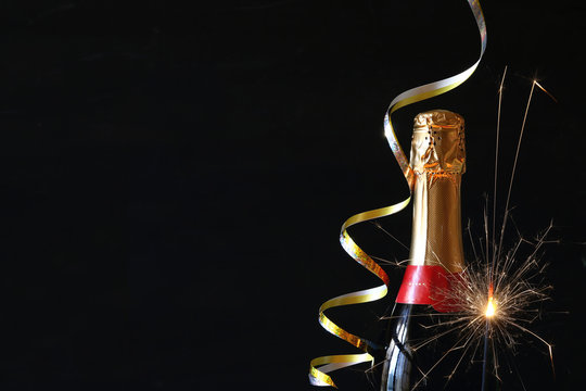 image of champagne bottle and festive lights