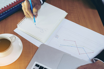 Handwriting success on a notebook with cup of coffee