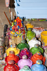Paint bottles, brushes and paint cans